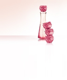 Kriska. Por días más femeninos. Nuevo perfúme Kriska Descoberta. Mujer sonrie y huele una flor